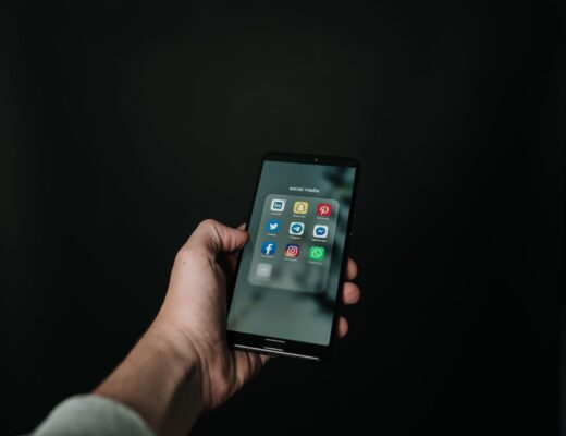 photo of hand holding a black smartphone