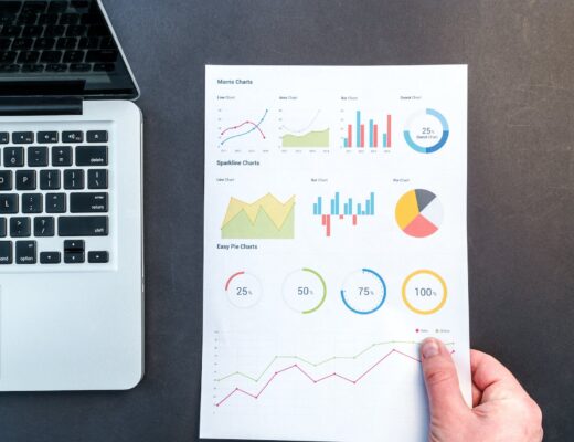 person holding chart and bar graph