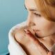 close up of woman smelling a cream on her fingers