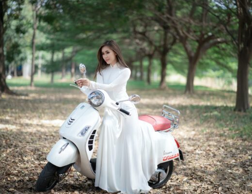 fashionable woman in bridal dress on motorcycle