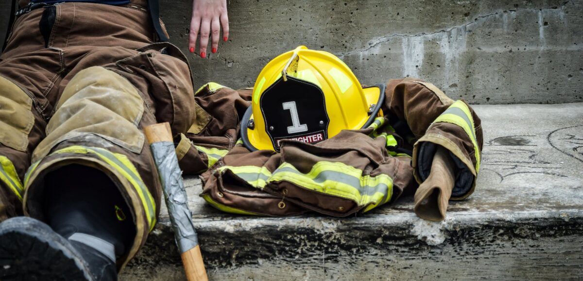 yellow hard hat on brown and yellow fireman s suit