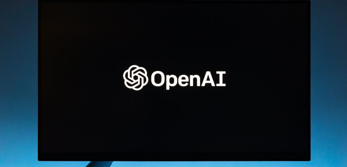 monitor screen with openai logo on black background