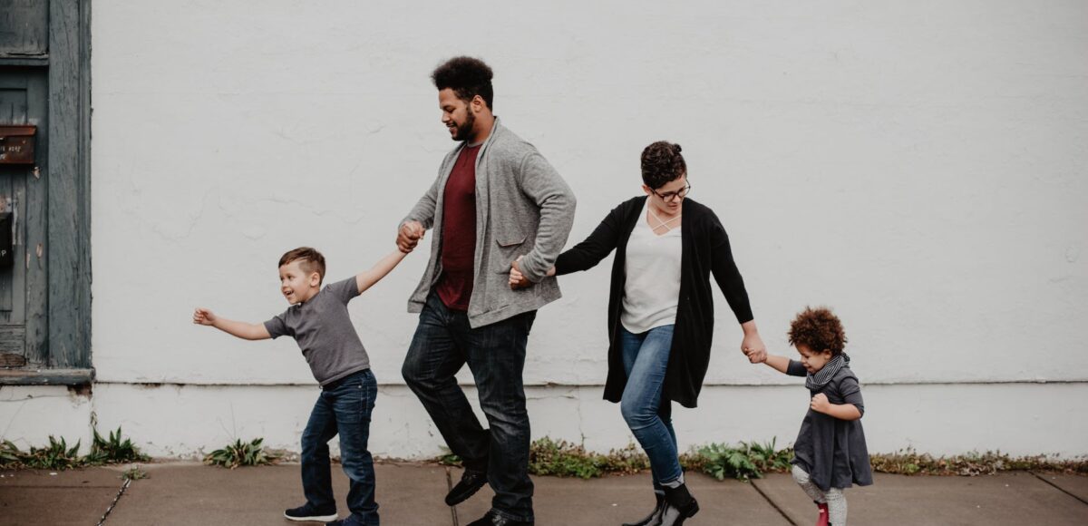 family of four walking at the street