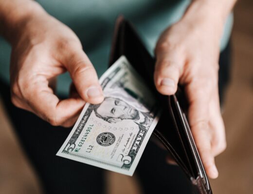 unrecognizable man holding wallet with money