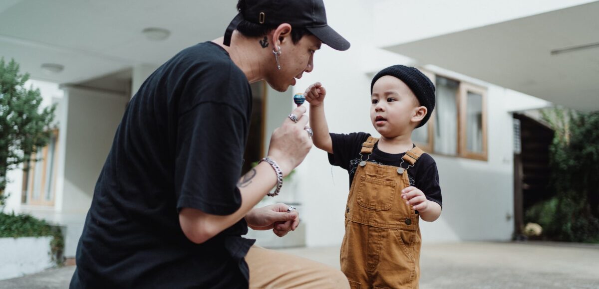 father negotiating lollipop with son