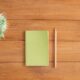 white notes beside a pencil on brown wooden surface