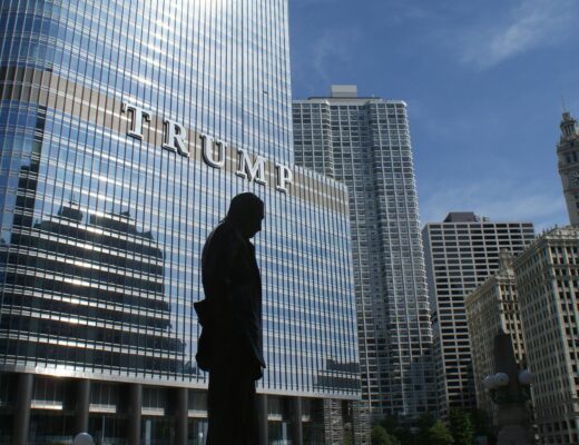 silhouette of statue near trump building at daytime