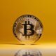 bitcoin on yellow studio background