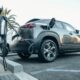 gray electric car parked on a charging bay