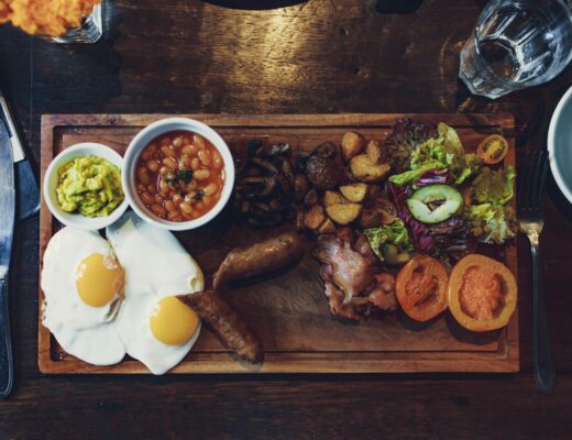 grilled vegetables and fried egg with beans and sausage